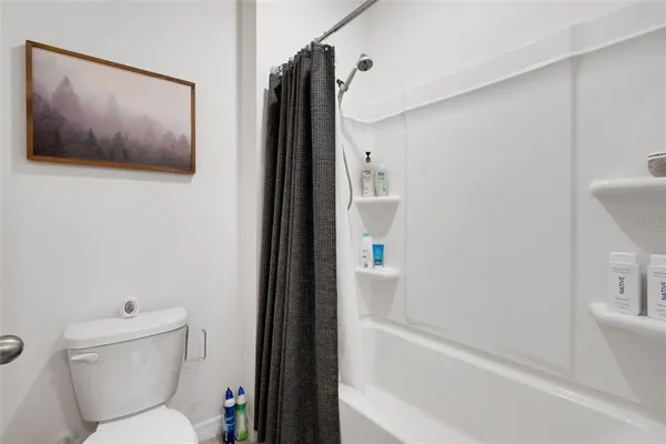 a bathroom with a toilet and a shower