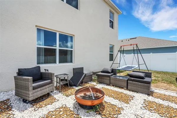 a living room with furniture a rug and a wall painting