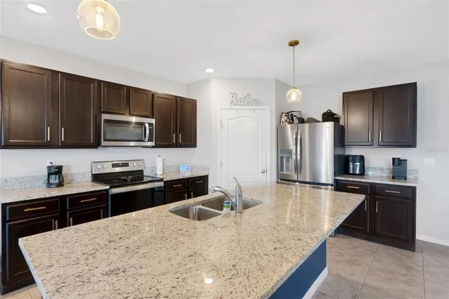 a kitchen with stainless steel appliances granite countertop a sink microwave and stove