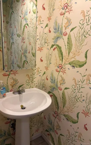 a white toilet sitting next to a shower