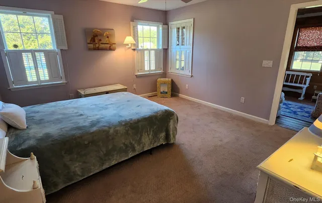 a spacious bedroom with a bed and a window