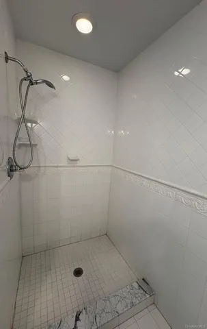 a bathroom with a bathtub and a window