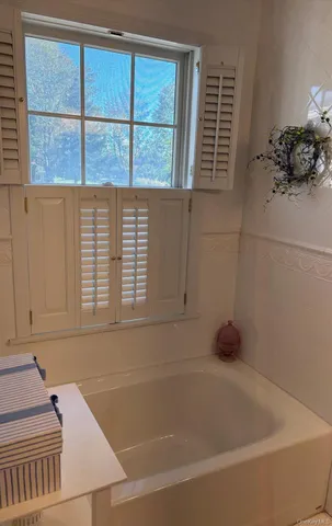 a living room with wooden floor and a chandelier