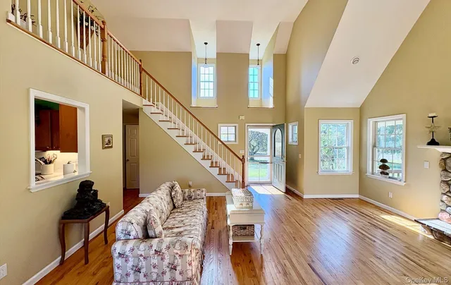a view of a livingroom with furniture and staircase