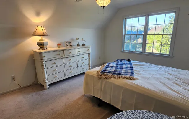a bedroom with two beds and window