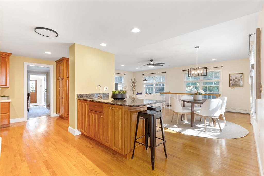 55 Berkshire Road Needham, MA 02492 - Photo 11 of 33 a dining hall with stainless steel appliances granite countertop a table chairs and a white cabinets