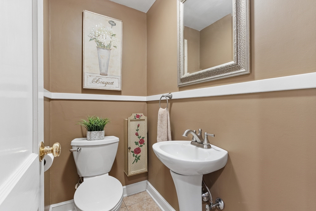 55 Berkshire Road Needham, MA 02492 - Photo 14 of 33 a bathroom with a toilet sink and mirror