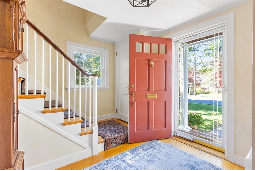 55 Berkshire Road Needham, MA 02492 - Photo 16 of 33 a view of a hallway with wooden floor and windows