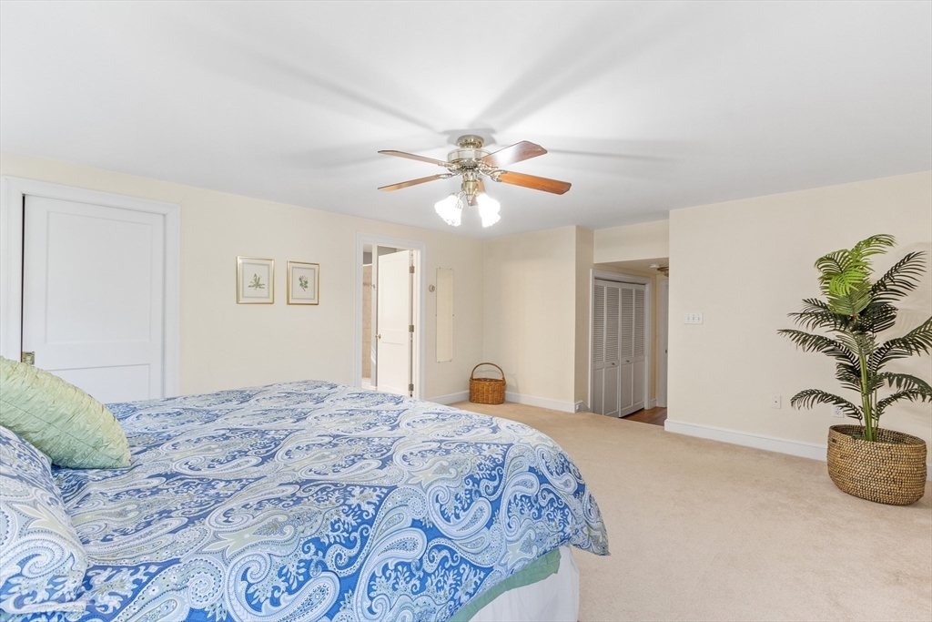 55 Berkshire Road Needham, MA 02492 - Photo 18 of 33 a bedroom with a large bed and a chandelier