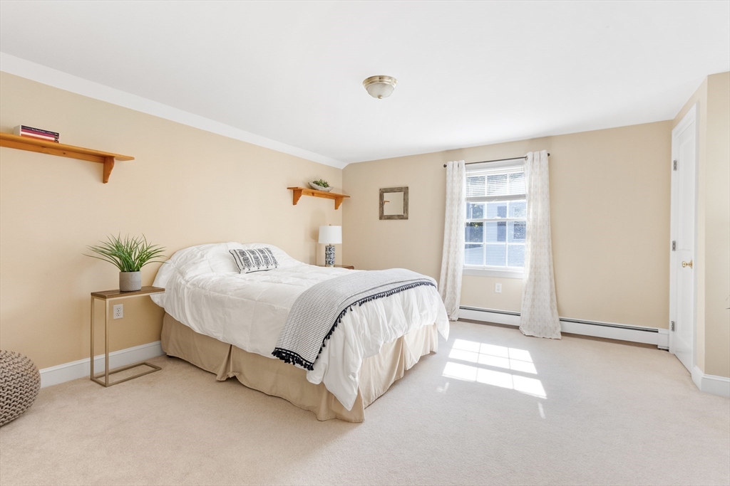 55 Berkshire Road Needham, MA 02492 - Photo 21 of 33 a spacious bedroom with a bed and a window