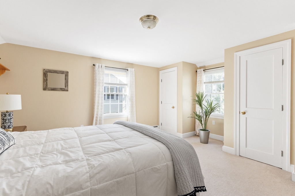 55 Berkshire Road Needham, MA 02492 - Photo 22 of 33 a spacious bedroom with a bed and a window
