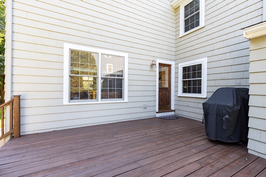 55 Berkshire Road Needham, MA 02492 - Photo 30 of 33 a view of a deck with wooden cabinets and wooden floor