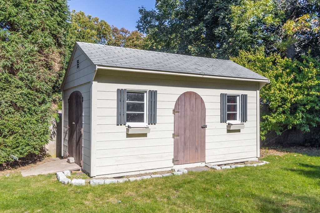 55 Berkshire Road Needham, MA 02492 - Photo 31 of 33 a front view of a house with a garden