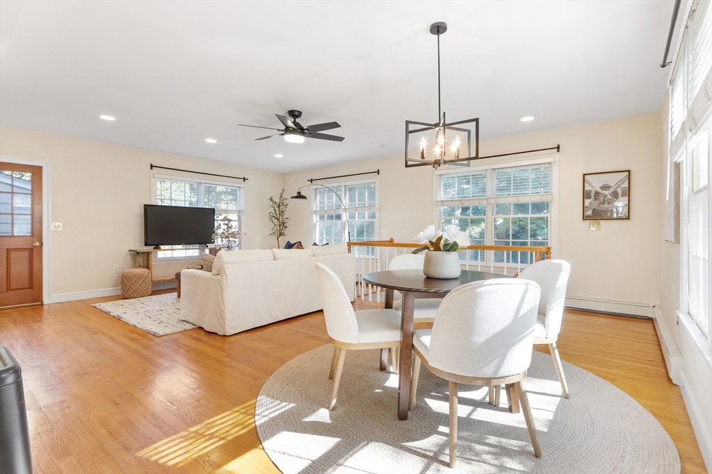 55 Berkshire Road Needham, MA 02492 - Photo 6 of 33 a living room with furniture a flat screen tv and kitchen view