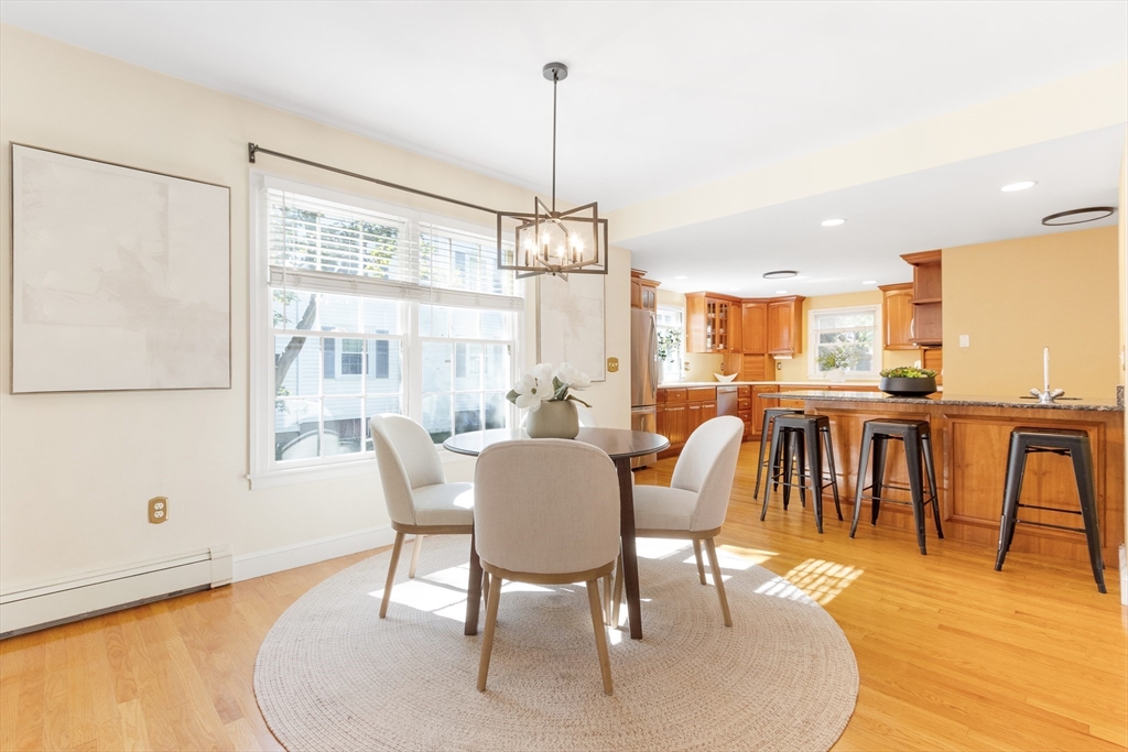 55 Berkshire Road Needham, MA 02492 - Photo 7 of 33 a dining room with furniture a chandelier and wooden floor