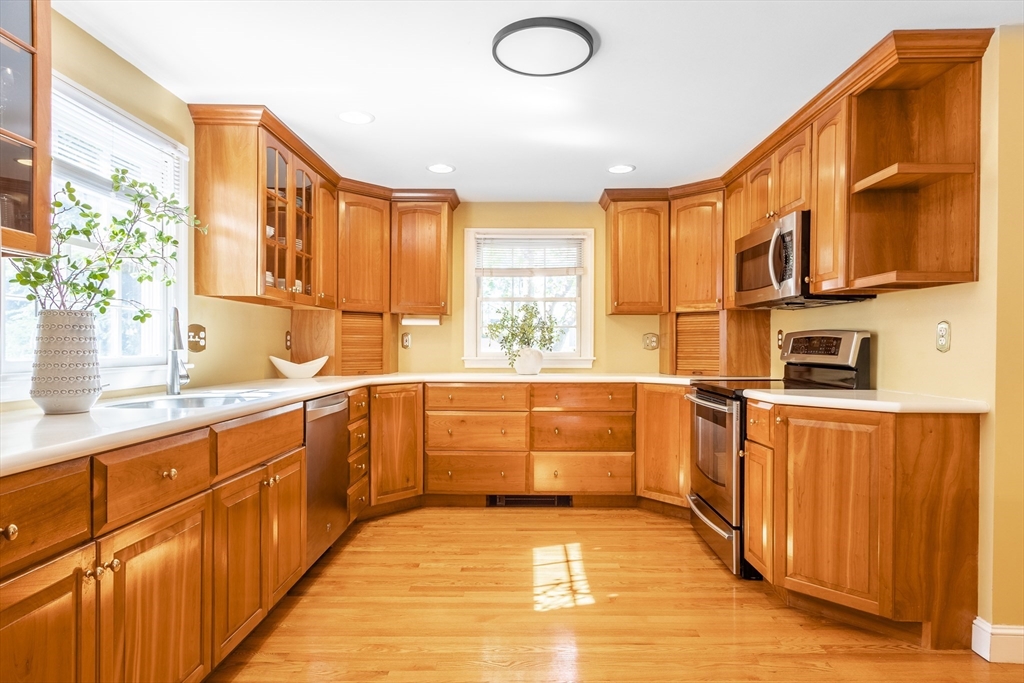 55 Berkshire Road Needham, MA 02492 - Photo 10 of 33 a kitchen with stainless steel appliances granite countertop a sink and cabinets