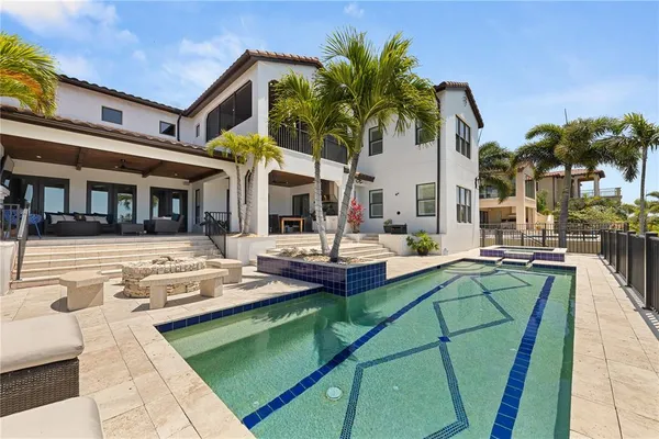 a view of a house with swimming pool and sitting area