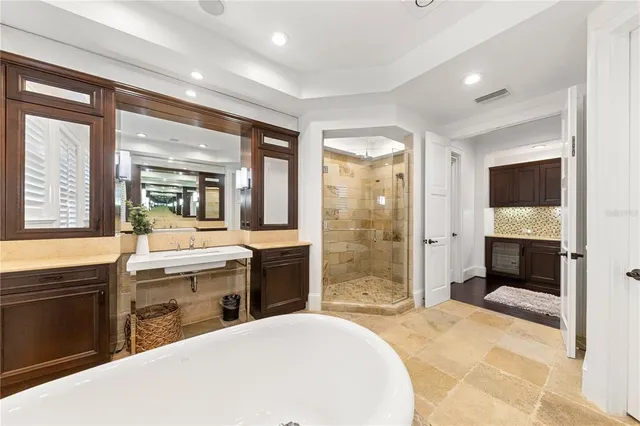 a spacious bathroom with a granite countertop tub and a sink