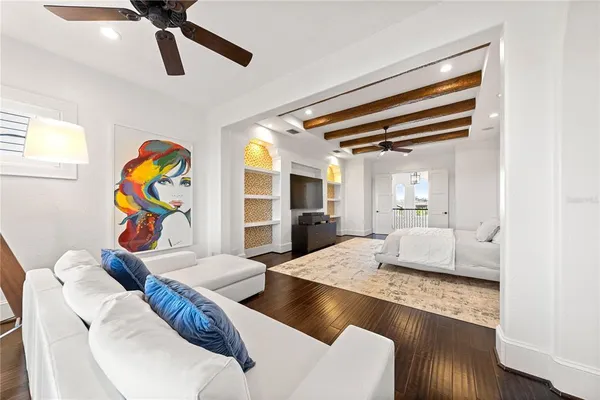 a bedroom with furniture and a large window