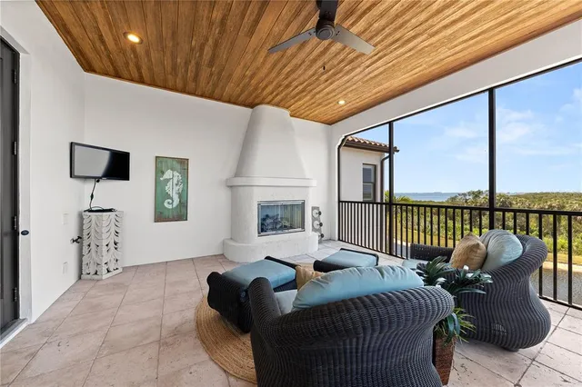 a view of staircase with lots of frames on wall and a view of living room