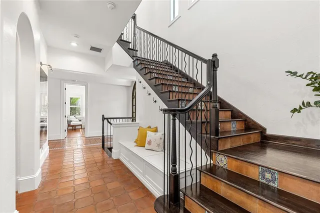a view of a hallway with wooden floor and staircase