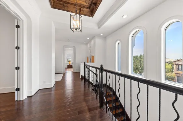 a bedroom with a bed wooden floor and window