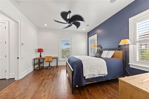 a bathroom with a granite countertop sink a mirror and shower