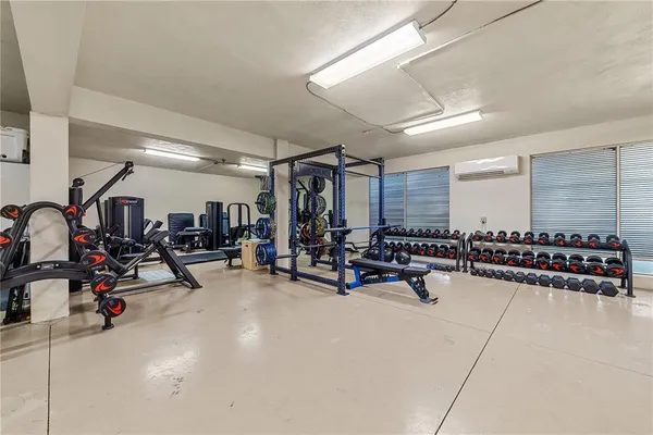 a living room with furniture a flat screen tv and a large window