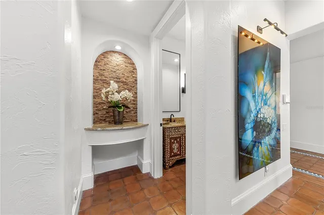a dining room with wooden floor a chandelier a wooden table and chairs