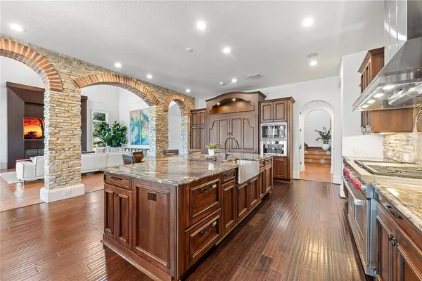 a kitchen with stainless steel appliances granite countertop a stove and a large cabinets