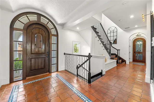a view of a hallway to a livingroom with furniture and a hallway