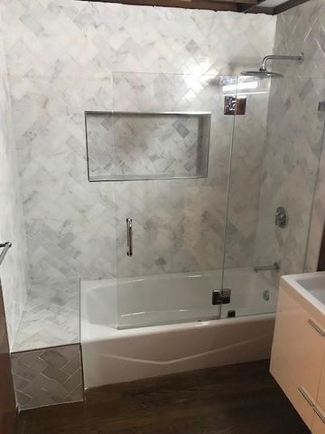 a bathroom with a bathtub and a shower