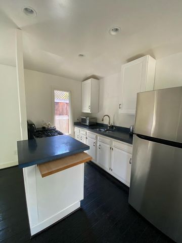 a kitchen with a sink a stove and refrigerator