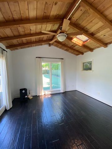 a view of room with wooden floor and windows