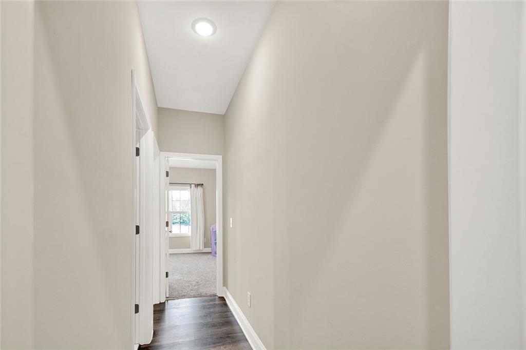 407 Corinth Church Road Winder, GA 30680 - Photo 46 of 66 a view of a hallway with wooden floor and closet