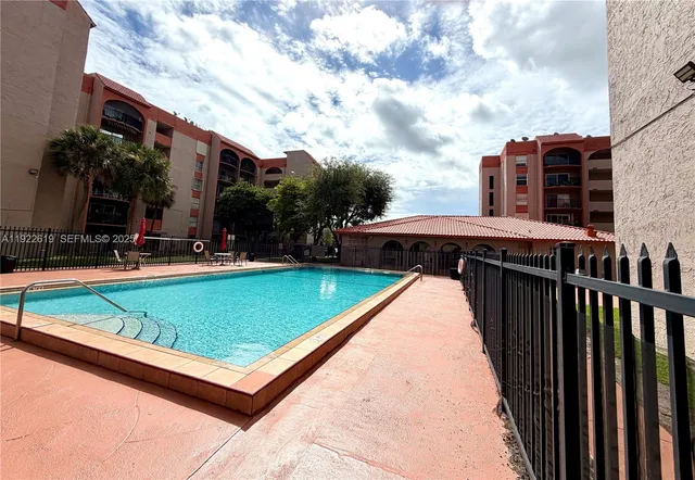 a bedroom with furniture and large glass door