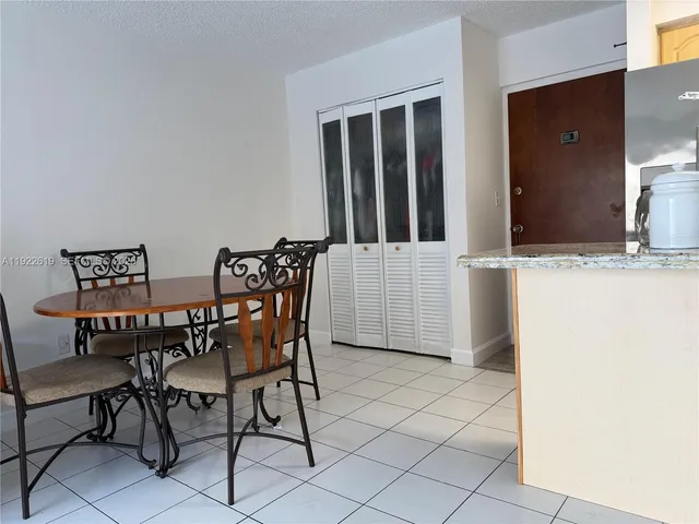 a living room with furniture a flat screen tv and floor to ceiling window