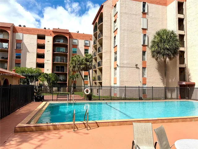 a view of a building with a backyard