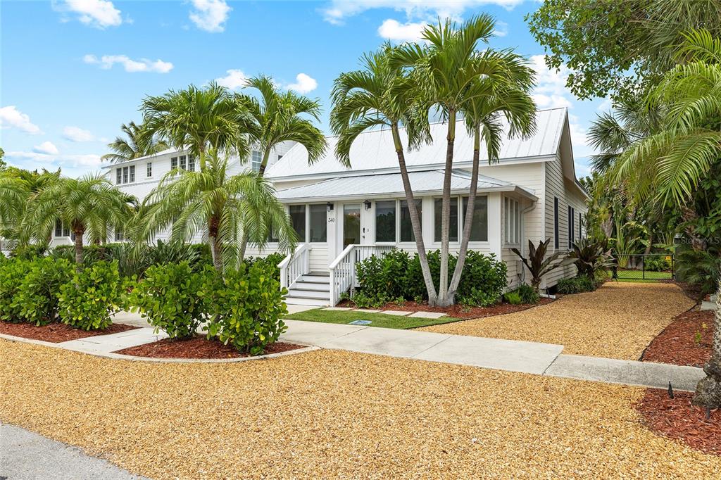 340 Palm Avenue Boca Grande, FL 33921 - Photo 4 of 38 a front view of a house with a garden