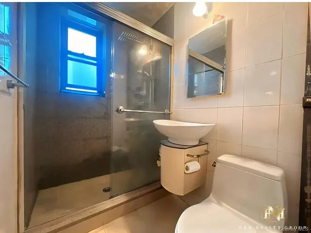 a white toilet sitting next to a bathroom sink