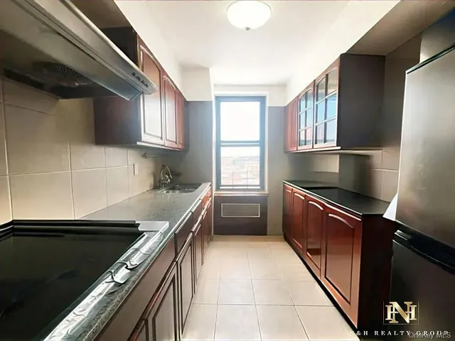 a kitchen with a refrigerator and a sink