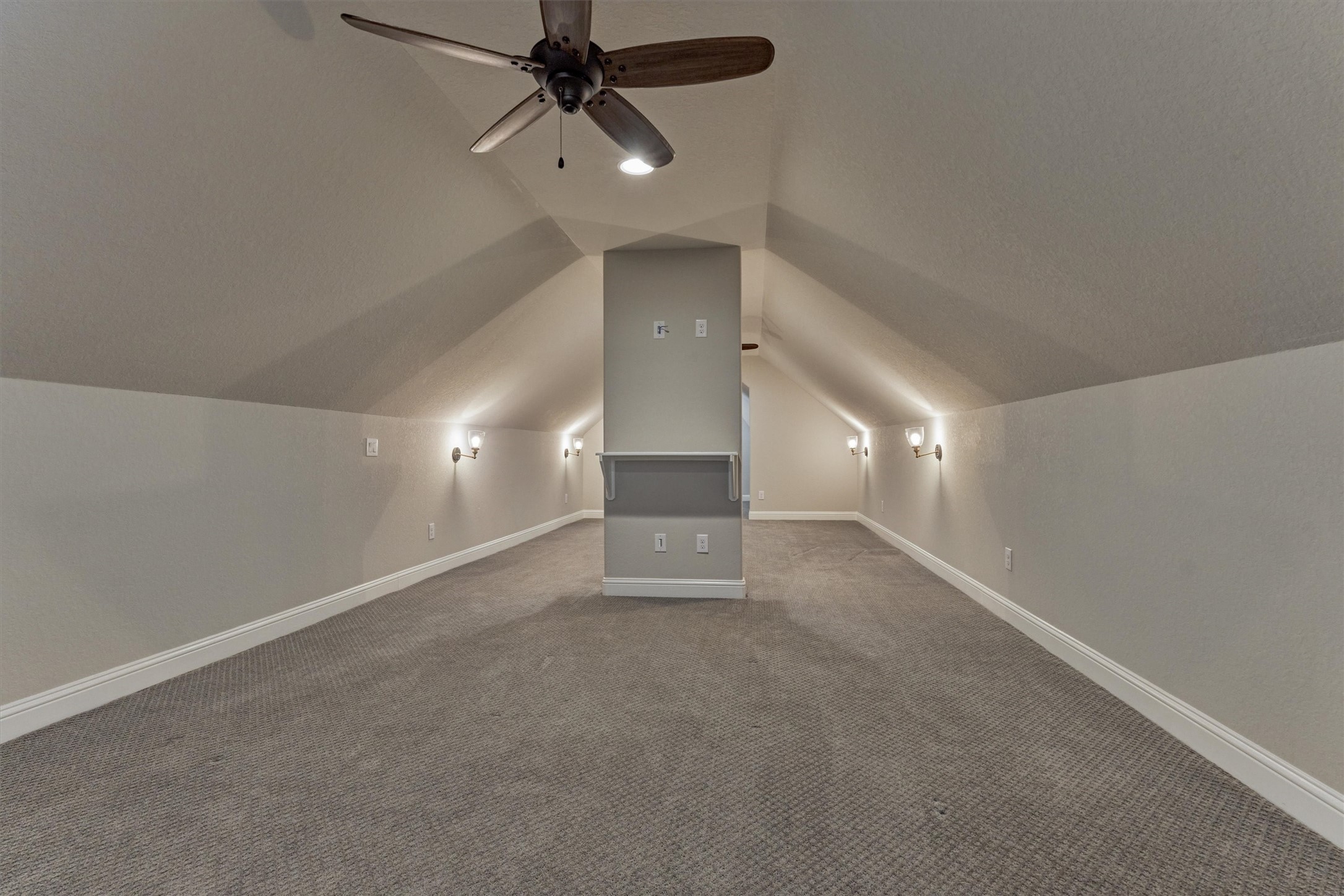 11618 Renaissance Drive Montgomery, TX 77356 - Photo 31 of 49 The game room features ceiling fans and wall sconces, creating a comfortable and inviting atmosphere. This versatile space would make an ideal gaming space, media room, or hobby area.
