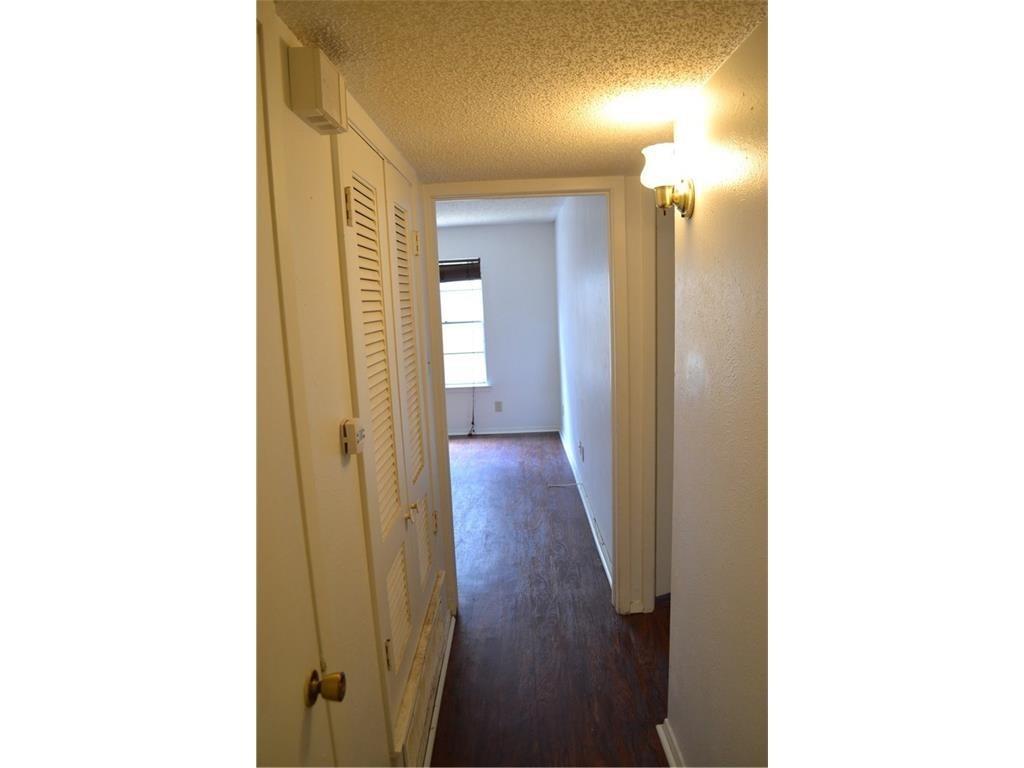 1107 North Locust Street, Unit 2 Denton, TX 76201 - Photo 2 of 8 a view of a hallway with wooden floor
