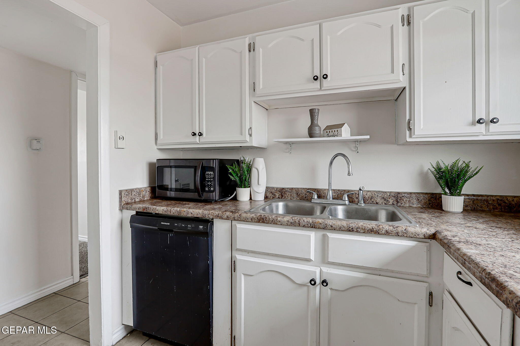 4956 Rutherford Drive El Paso, TX 79924 - Photo 12 of 41 a kitchen with granite countertop white cabinets and a sink
