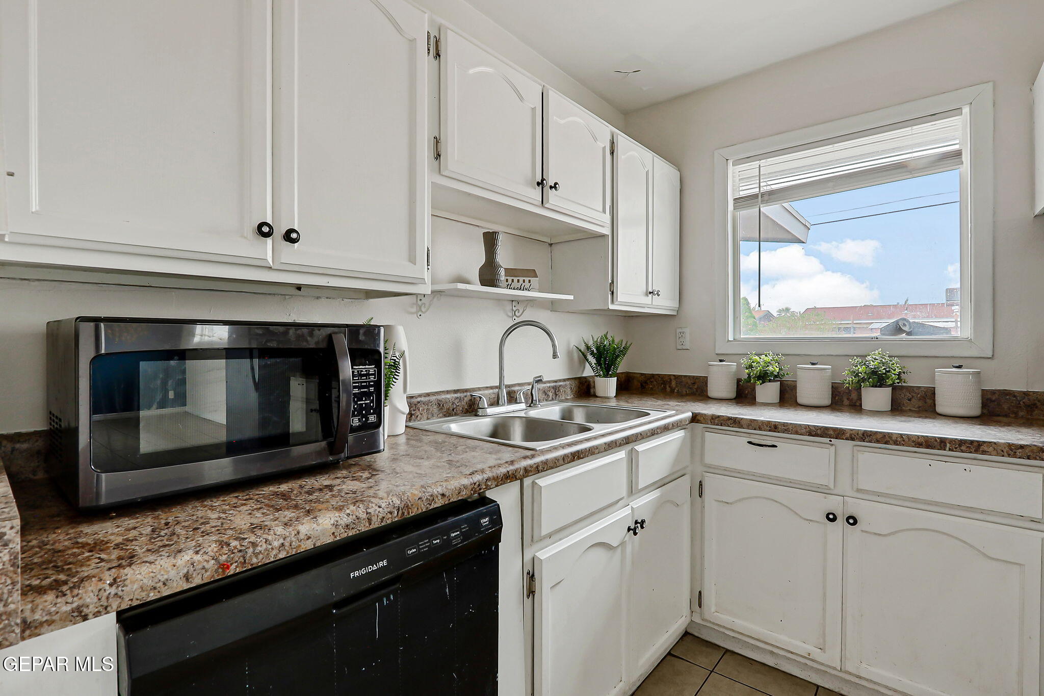 4956 Rutherford Drive El Paso, TX 79924 - Photo 14 of 41 a kitchen with granite countertop white cabinets white stainless steel appliances and a sink