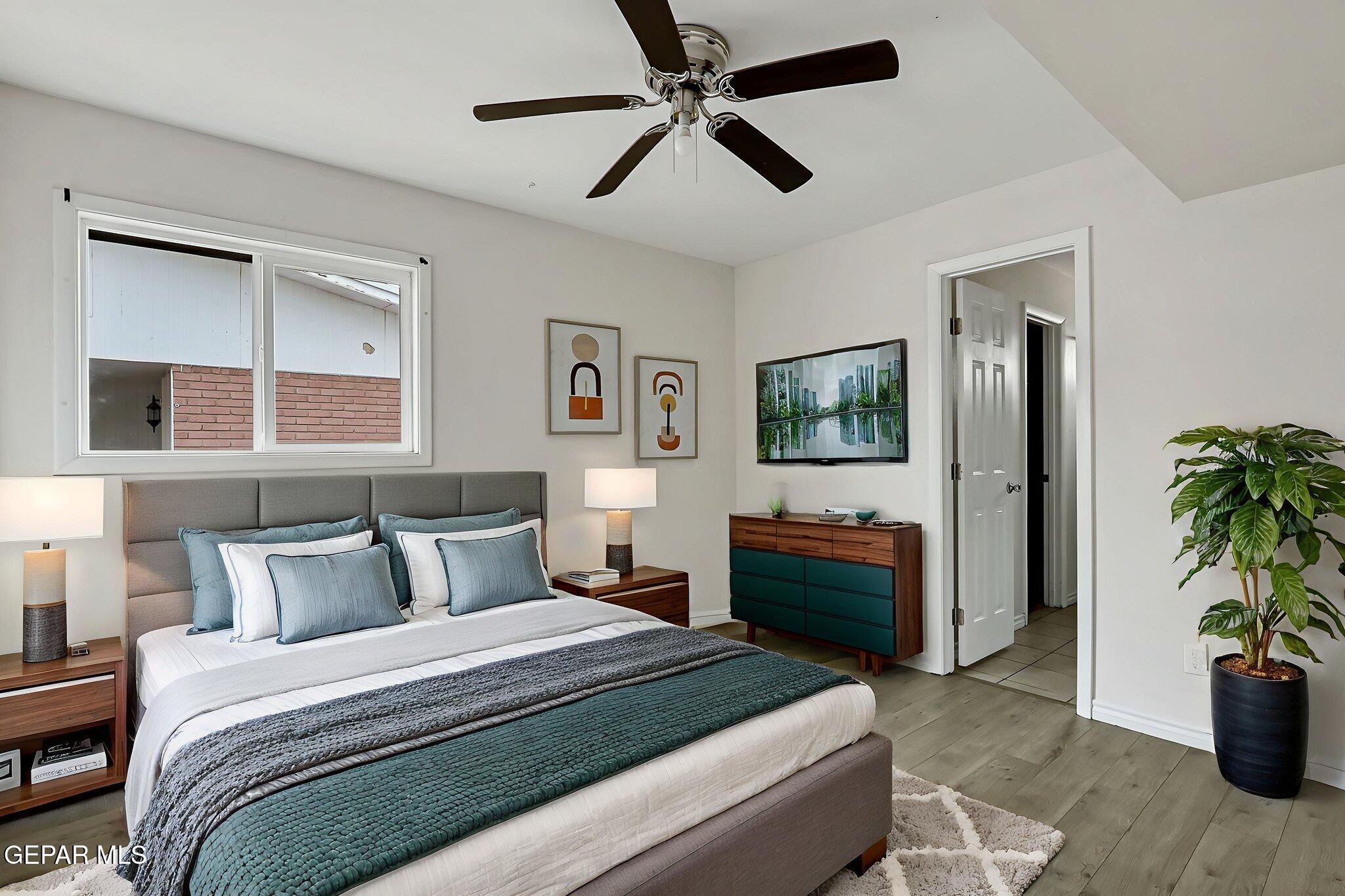 4956 Rutherford Drive El Paso, TX 79924 - Photo 15 of 41 a bedroom with a bed and a potted plant