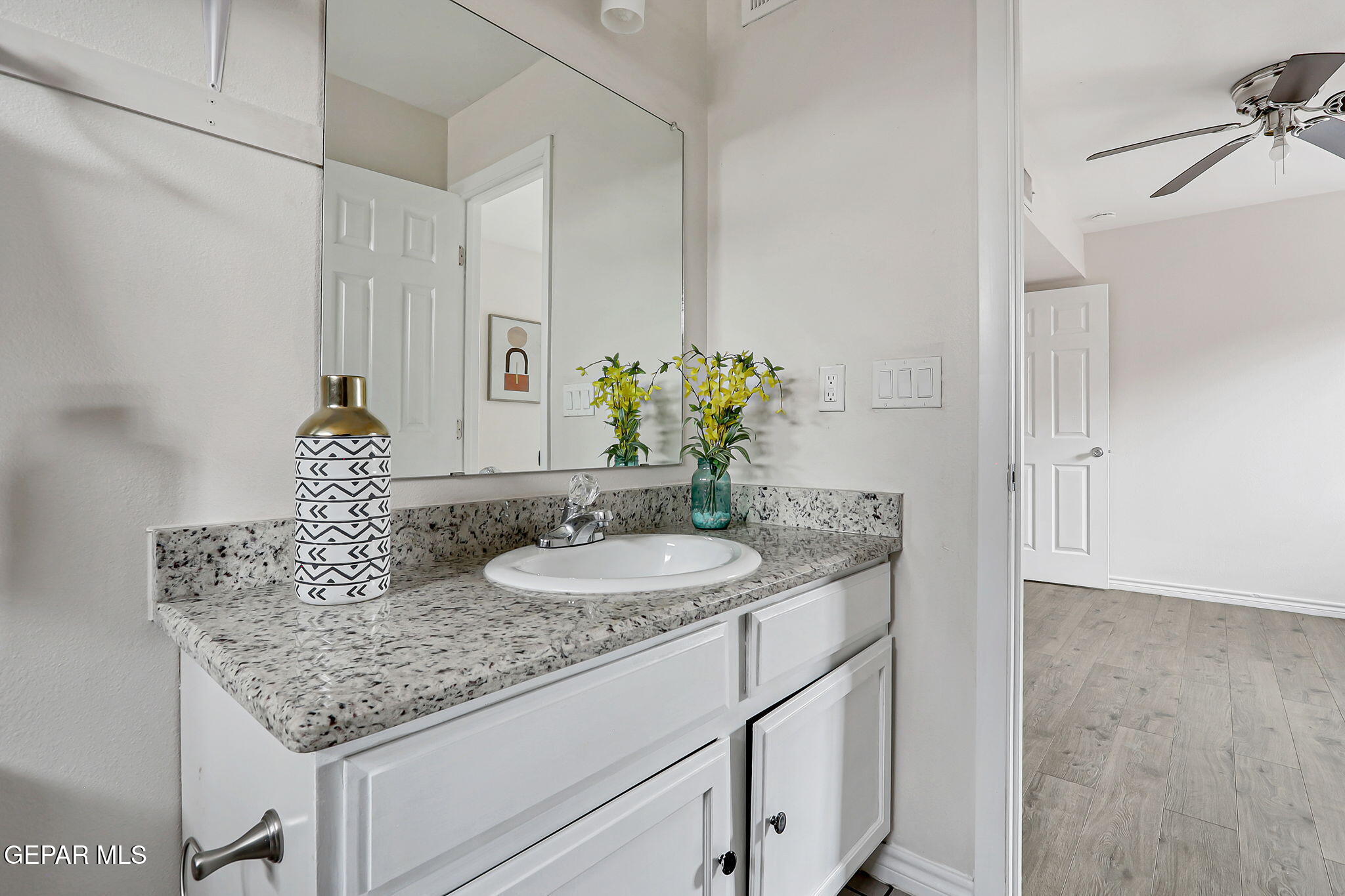 4956 Rutherford Drive El Paso, TX 79924 - Photo 20 of 41 a bathroom with a granite countertop sink and a mirror