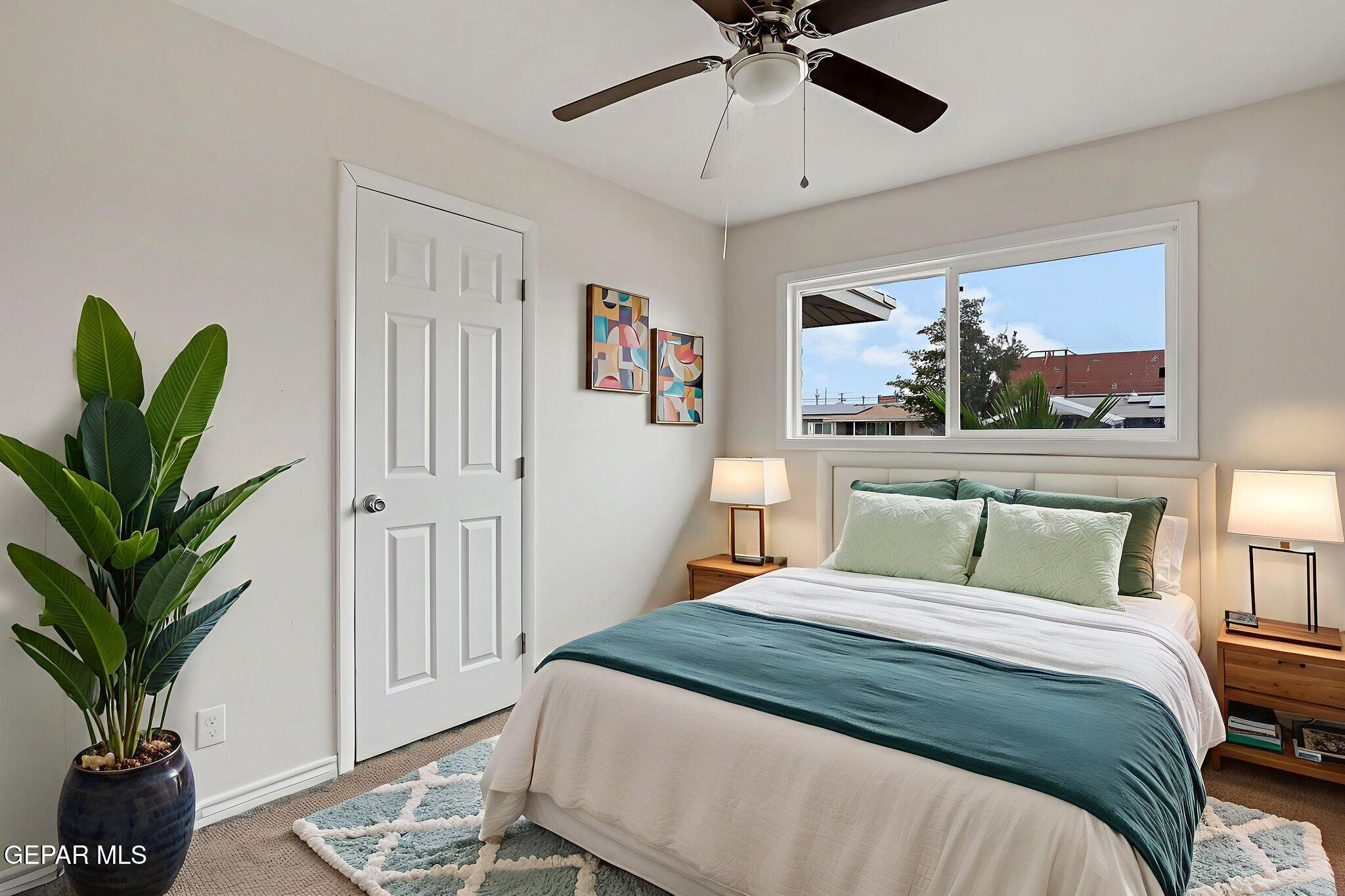 4956 Rutherford Drive El Paso, TX 79924 - Photo 24 of 41 a bedroom with a large bed and a chandelier