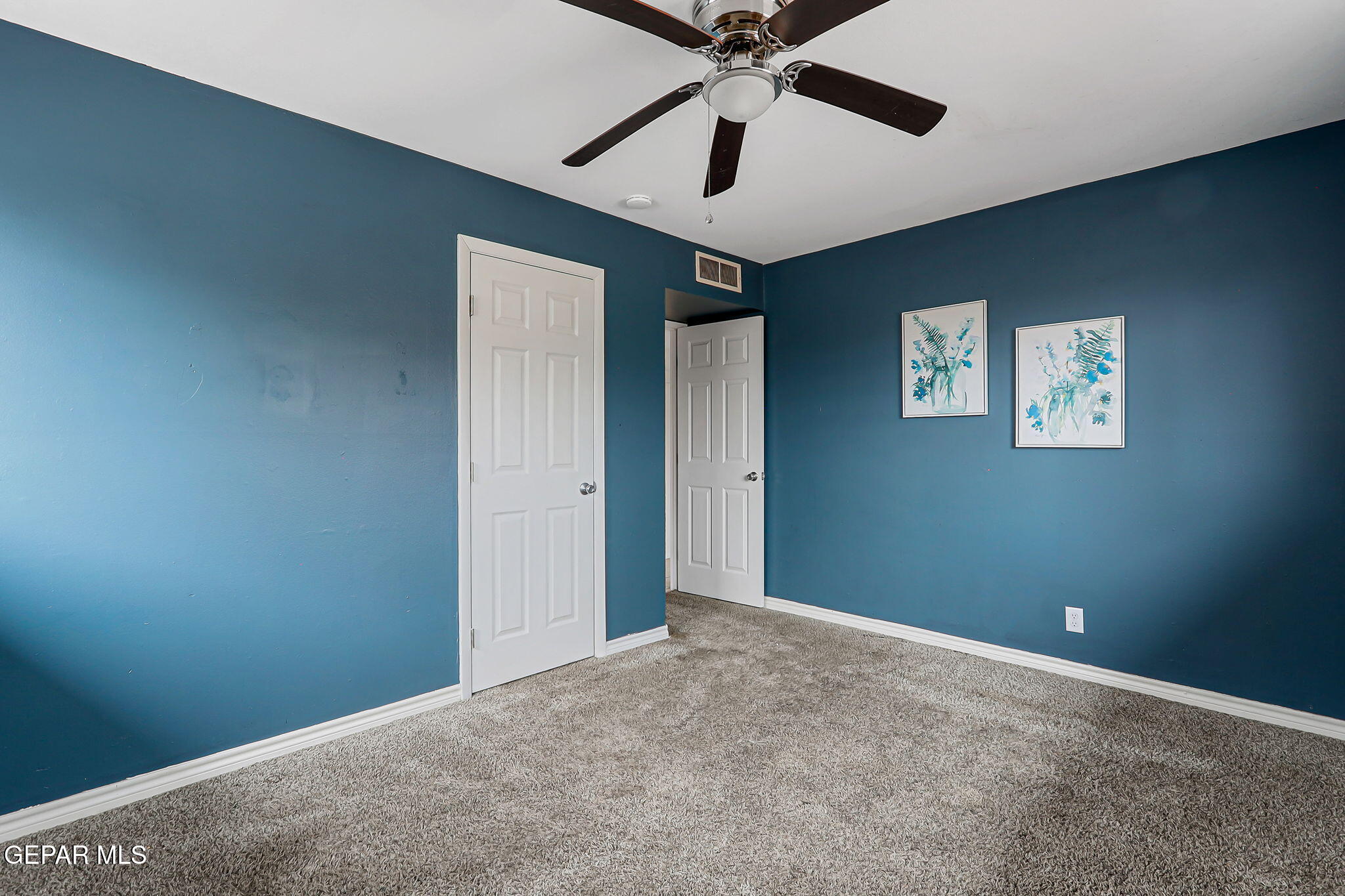 4956 Rutherford Drive El Paso, TX 79924 - Photo 27 of 41 an empty room with windows and fan
