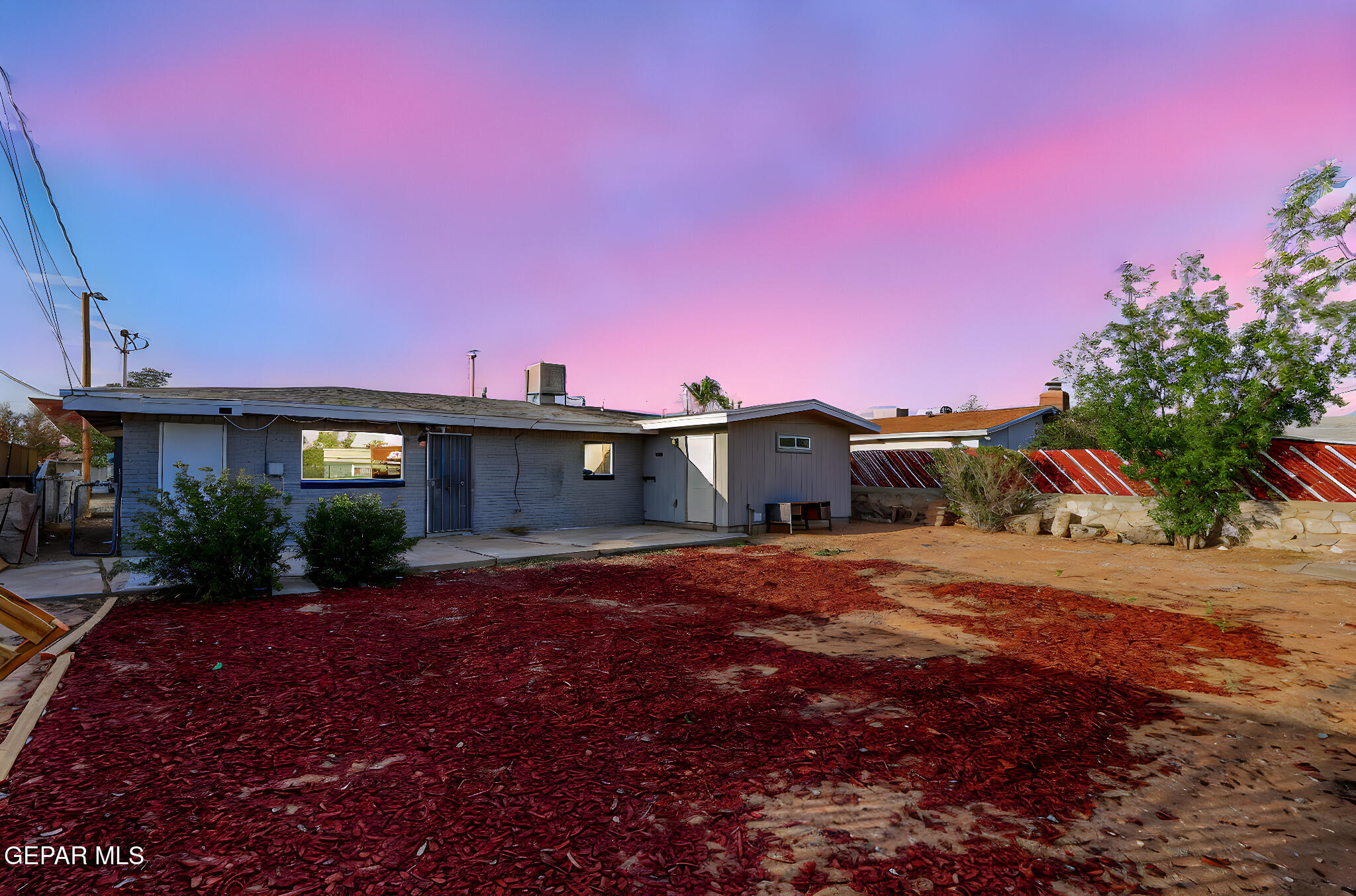 4956 Rutherford Drive El Paso, TX 79924 - Photo 30 of 41 a front view of a house with a yard and garage
